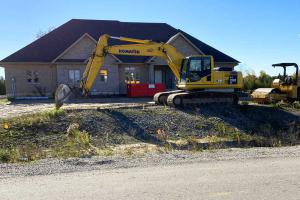Grading outside a residential home.